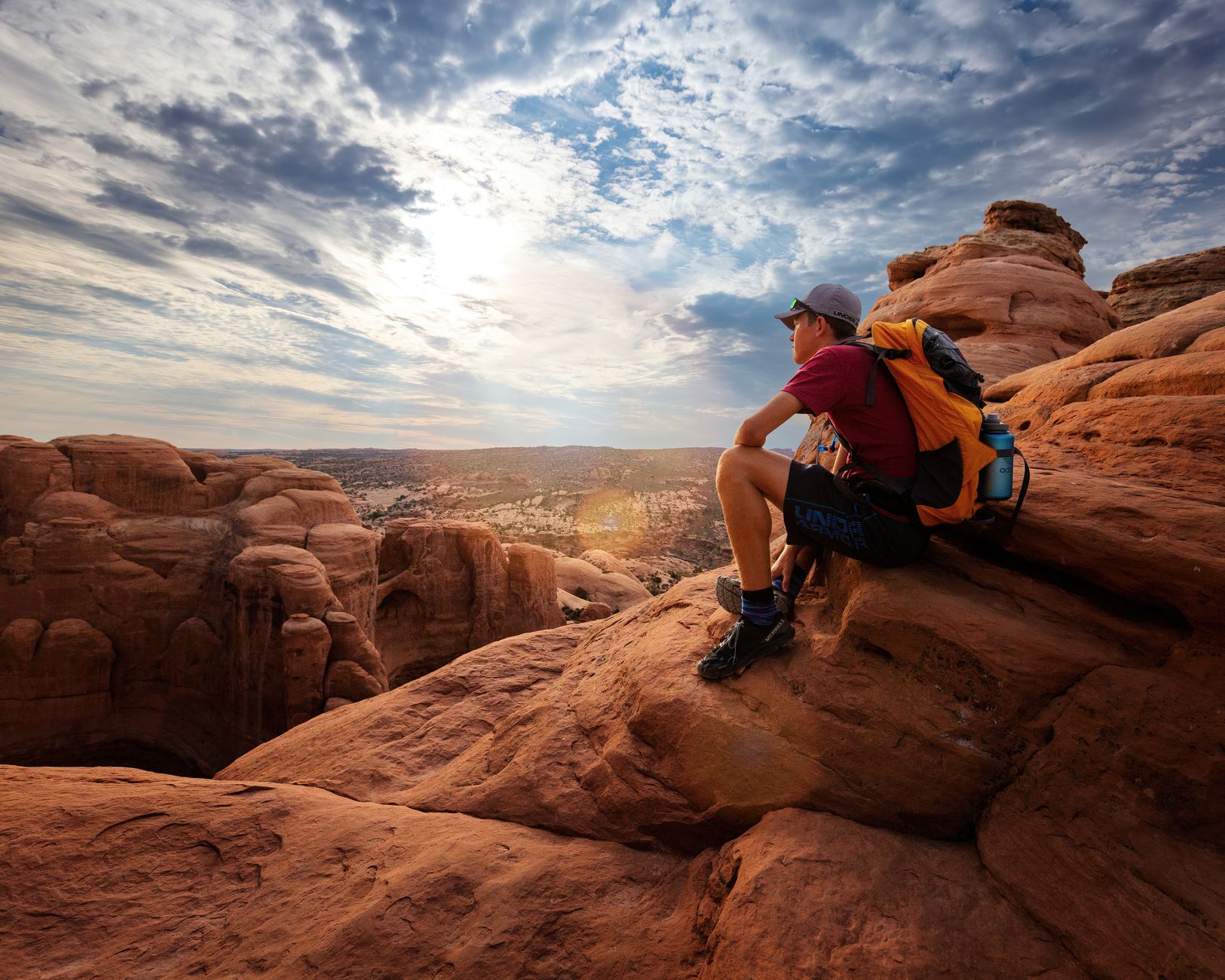 Minimalist backpacker taking in vast desert valley